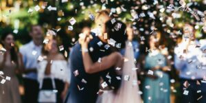 White confetti falls over wedding couple dancing on the porch - Wedding & Events by Raymonde